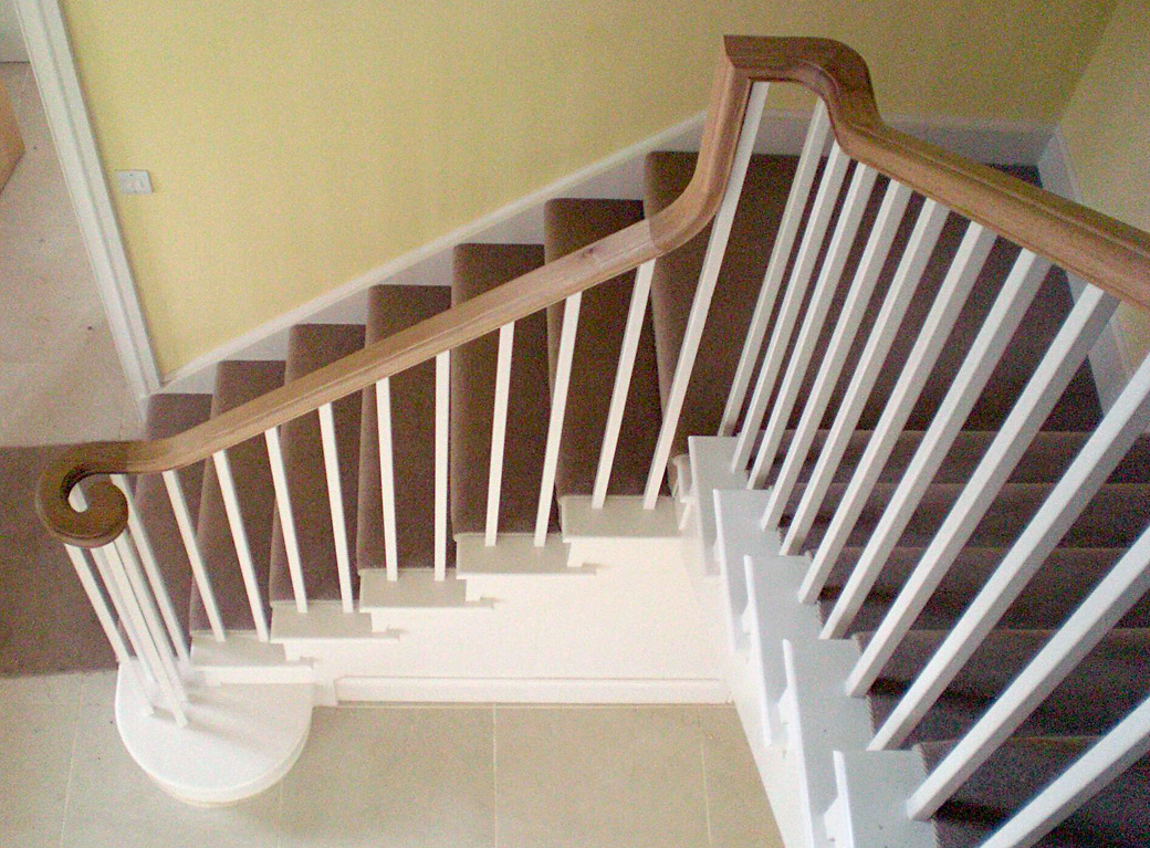 Painted staircase with oak continuous handrail Painted staircase with oak continuous handrail