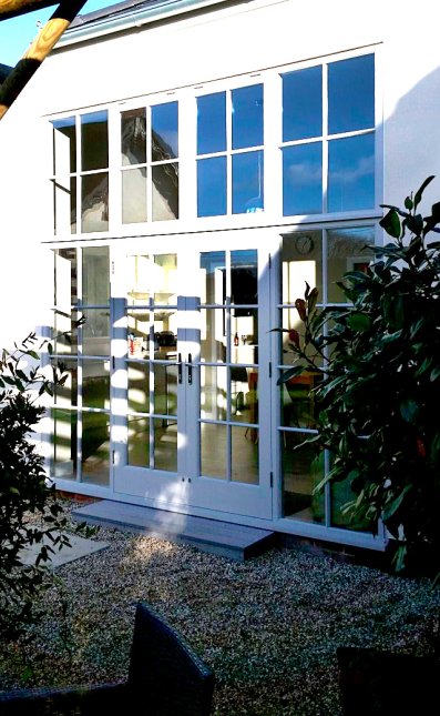 Pair of glazed doors with matching side light and windows above